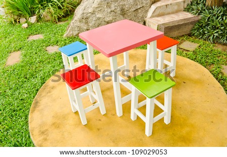 colorful chairs and table in garden
