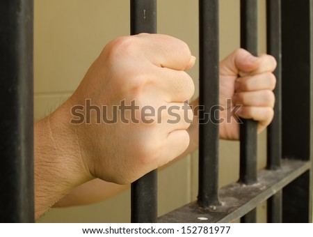 Hands on jail bar