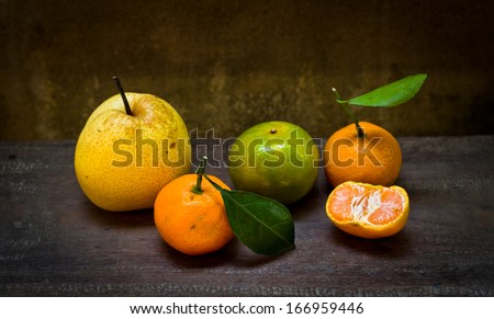 Fresh orange and pear on an old wood table,still life