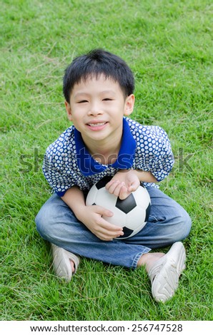 Young Asian boy with his ball in the park
