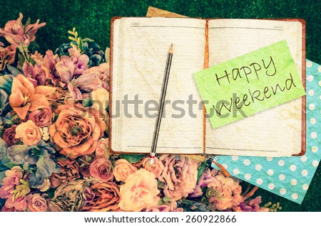 Happy weekend on note book and flower bouquet with vintage filter