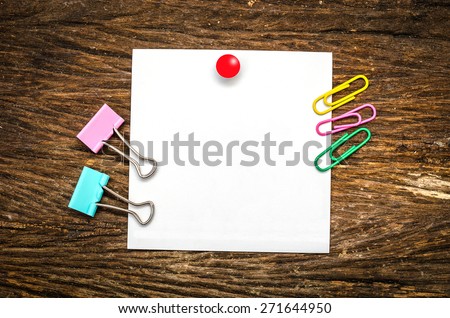 Paper note with clip on wooden table