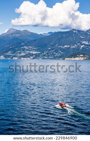 Power boat speeding on Lake Como. European vacation, living, life style, architecture, motor sports,  and travel concept.