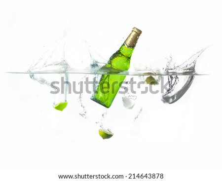 beer splashing with lime and ice cube