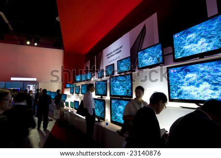 LAS VEGAS - JANUARY 8, 2009: People are looking at an impressive wall of TVs at the 2009 Consumer Electronic Show held in Las Vegas, Nevada, on January 8, 2009.