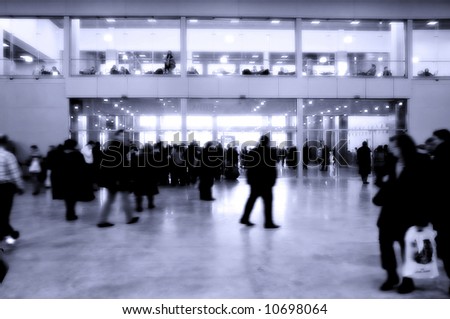 moving crowd in the interior of modern business building