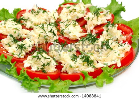 tomato slices covering with grated cheese with garlic and  fresh greenery