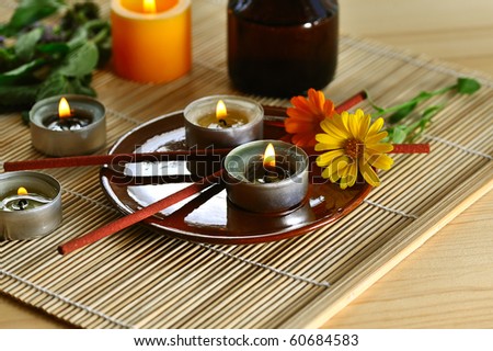 scened  burn candles with herbs and incense stick on wood background