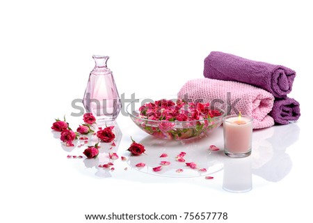 bowl with  rose petals, rose candle  and towels on white background