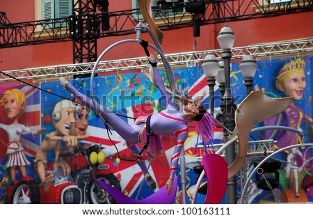 NICE, FRANCE - FEBRUARY 21: Carnival of Nice in French Riviera. This is the main winter event of the Riviera. 2012 theme is the King of Sport. Young woman gymnast Nice, France - Feb 21, 2012