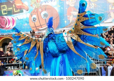 NICE, FRANCE - FEBRUARY 21: Carnival of Nice in French Riviera. This is the main winter event of the Riviera. The artist dressed in the costume of A Fantastic Blue Bird. Nice, France - Feb 21, 2012