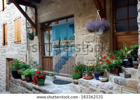 Cute flowering doors and windows in houses of Ardeche, France