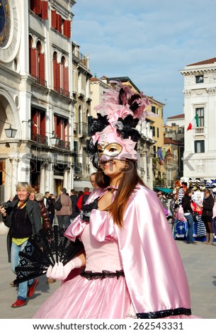 VENICE, ITALY - FEBRUARY 21: Beautiful woman wearing rose costume. The theme was Wonder and Fantasy Nature. The Venetian carnival is famous for its distinctive masks. Venice, Italy - Feb 21, 2014