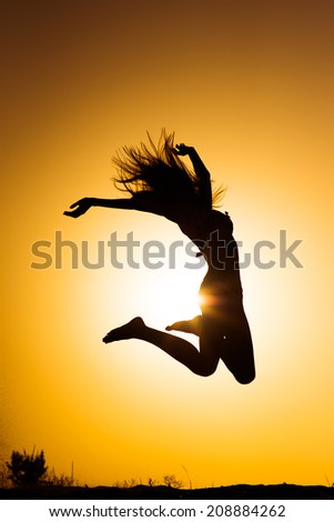 Jumping woman on the beach