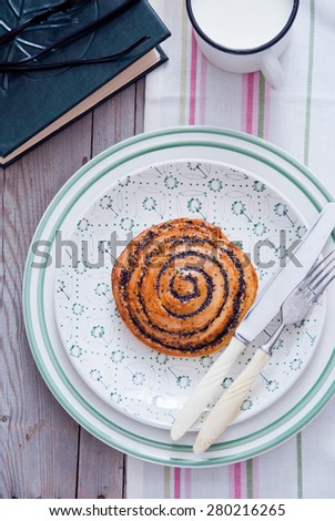 Puff scroll pastry, Sliced poppy seed roll,  Sweet poppy seed bun on a white plate