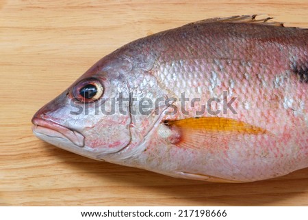 Red snapper fish on Wooden Chopping Block Board