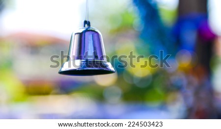Closeup of silver bell, christmas ornament hanging on tree