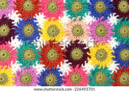 Crochet fabric flowers pattern in white background. Homemade.