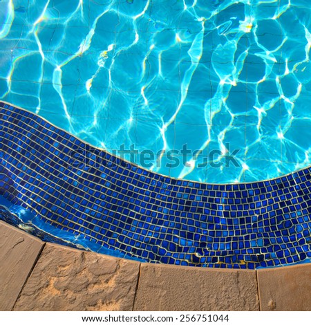 Blue tiles of jacuzzi in the Swimming pool blue water and sunlight reflection effect