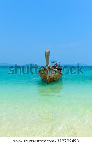 PHANG NGA,THAILAND - MARCH 24 :  Group tourists traveling by Long tail boat on blue water of Andaman Sea in summer at Khai Nok island. - 24 March 2015, Phuket , Thailand.