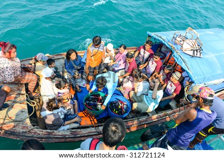 PHUKET, THAILAND - MARCH 24, 2015: Group tourists traveling by Long tail boat on blue water of Andaman Sea in summer at Phuket island. - 24 March 2015, Phuket , Thailand.