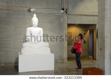 BANGKOK - AUGUST 30: Visitors are shooting the Buddha statue in Contemporary Art Exhibition on August 30, 2015 at Ratchadamnoen Contemporary Art Center in Bangkok, Thailand.
