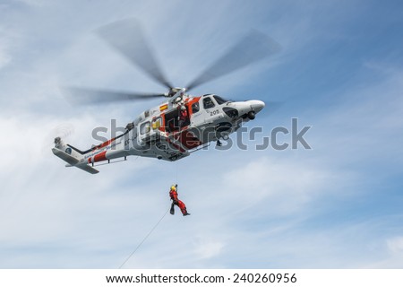 VALENCIA COAST, SPAIN - DECEMBER 25: The helicopter of the Spanish Maritime Rescue Team and his rescuers during rescue exercises, on December 25, 2014 in Valencia coast.