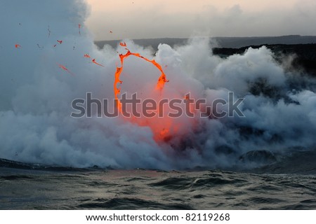 Kilauea volcano lava flow spitting into the air and ocean. Hawaii Volcanoes National Park.