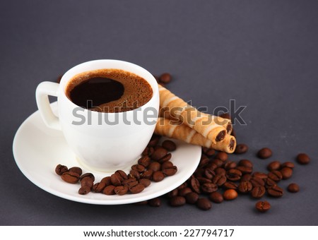 coffee and wafer rolls on a black background