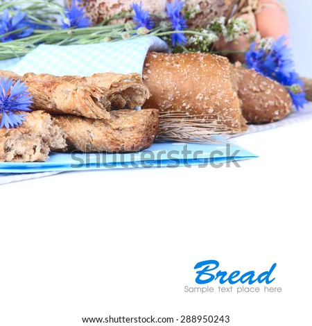 Fresh bread and wild flowers on a white background