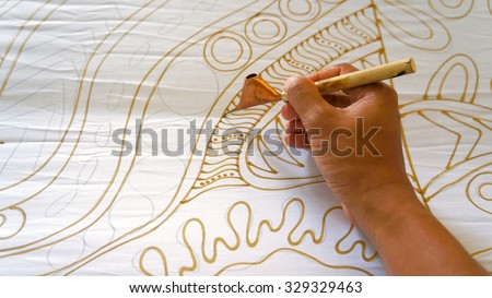 KUANTAN PAHANG, MALAYSIA - OCT 13 2015 : Unidentified local woman sketching freehand with canting tools and hot wax to create a traditional Batik Canting at workshop in Kuantan, Pahang Malaysia