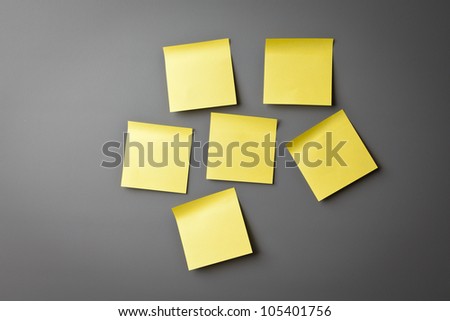 Yellow sticky notes on a grey wall