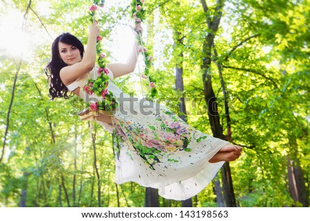 Young Woman Is Swinging On A Swing In Summer Forest Images