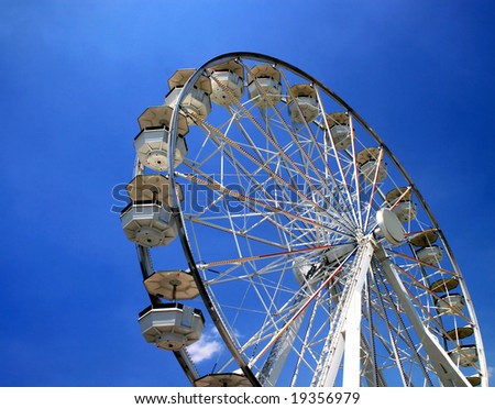 A ferris wheel in a fair ground.
