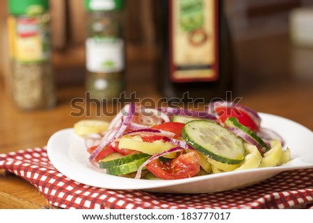 Healthy fitness salad with tomato,cucumber,onion,pepper,oregano,basil,olive oil