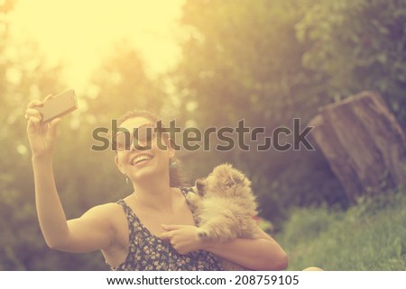 Vintage photo of woman taking a selfie with her dog