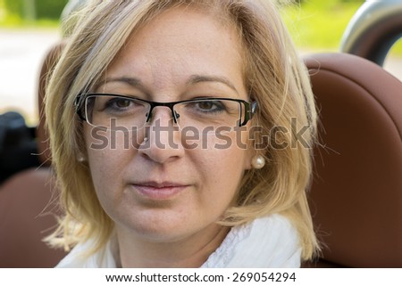 Natural blonde woman in cabrio sport car