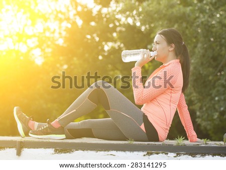 Tired runner woman drink water