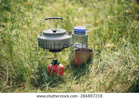 boiling water in titanium kettle on portable camping stove