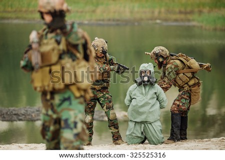 U.S. Army rangers captured a scientist with protective mask and protective clothes  during the military operation