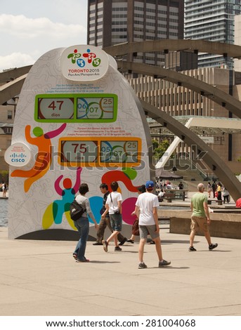 TORONTO - May 24, People passing by Pan Am and Parapan Am Games Countdown Clock located at Nathan Phillips Square showing the time left to the beginning of the games, May 24, 2015 in Toronto, Canada.