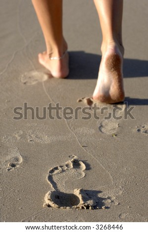 Foot prints in the sand leaving only memories