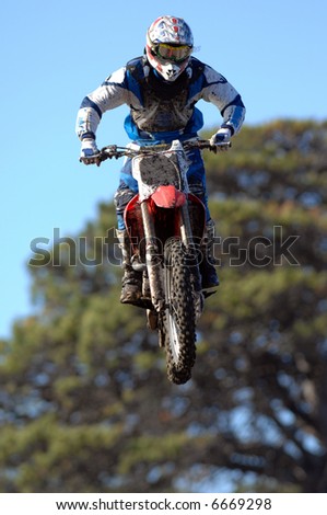 A motocross rider goes for air off a big jump