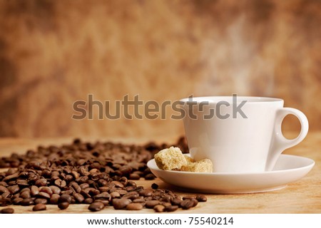 Coffee cup and roasted beans on vintage background