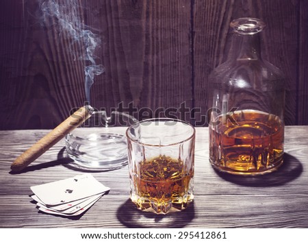 Cognac and cigar burning on a wooden table crafted in the style of instagramm