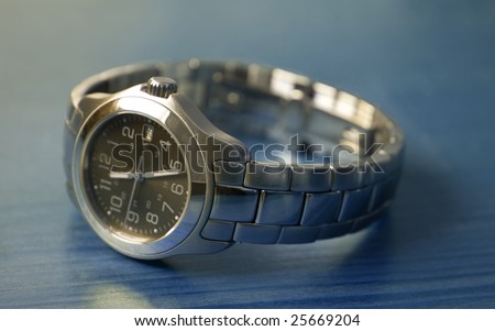 Ladies stainless steel watch on a blue wood table