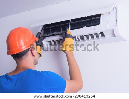 Placing back clean filter into air conditioner