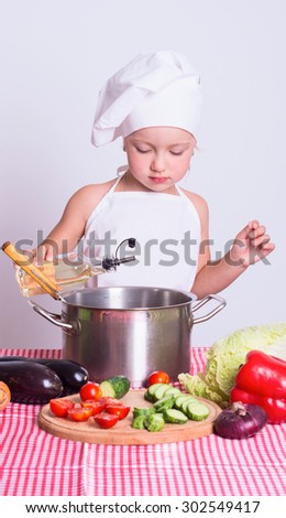 Little chef preparing a meal of vegetables