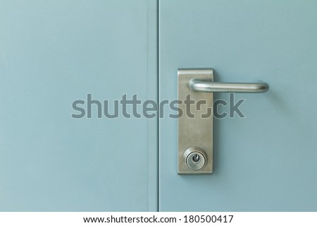 Close up of stainless steel door lock on industrial steel door