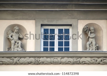 Window and statues of cupids in the old building in Lviv, Ukraine